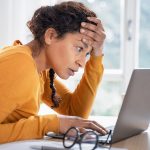 woman frustrated at computer from making common job search mistakes